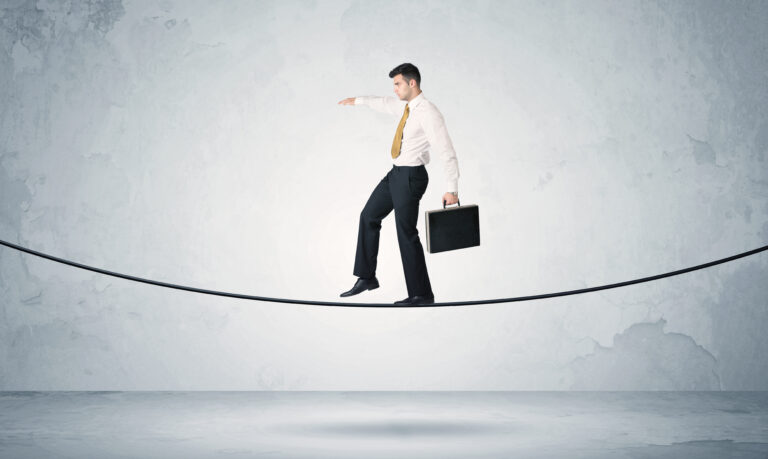 Sales guy balancing on tight rope