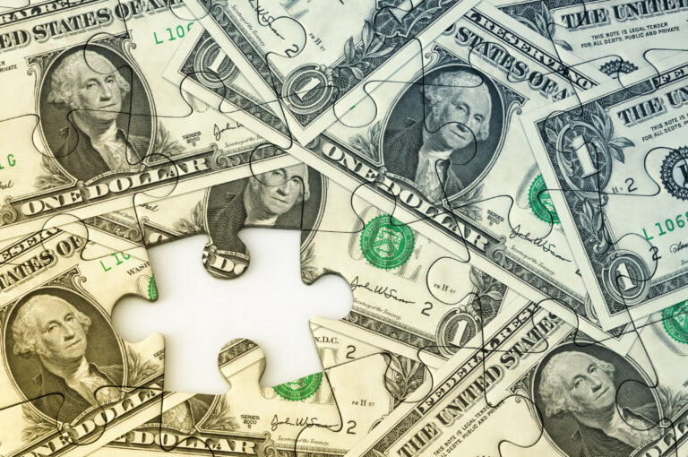 Dollar bank notes with jigsaw puzzle effect.